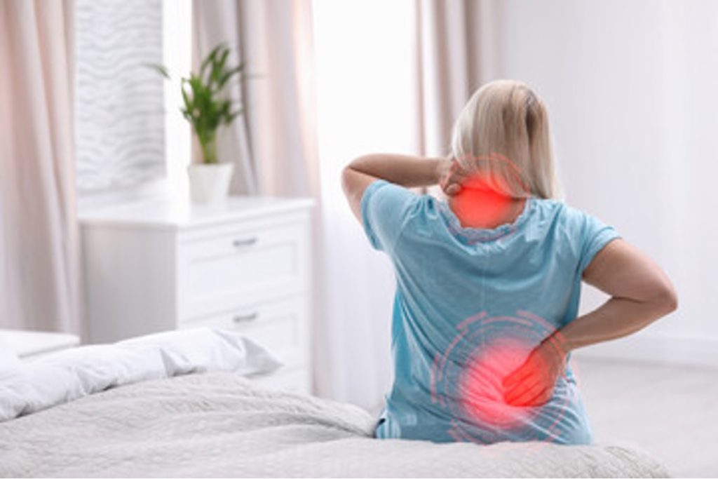 Woman sitting while showing chronic pain trigger points highlighted.