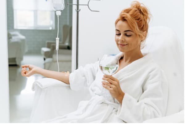 Woman receiving infusion therapy treatment in office.